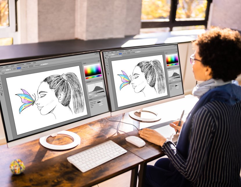 Graphic Designer Artist Working On Multiple Computer Screens